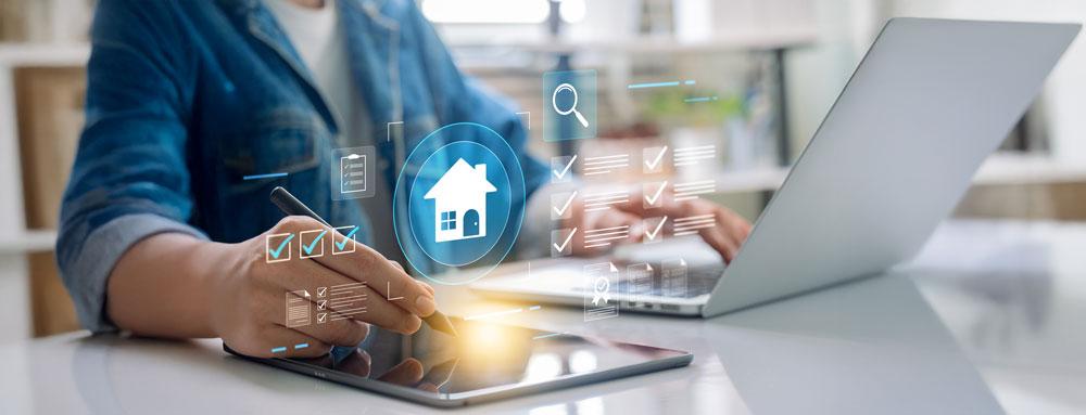 Person on laptop signing contracts